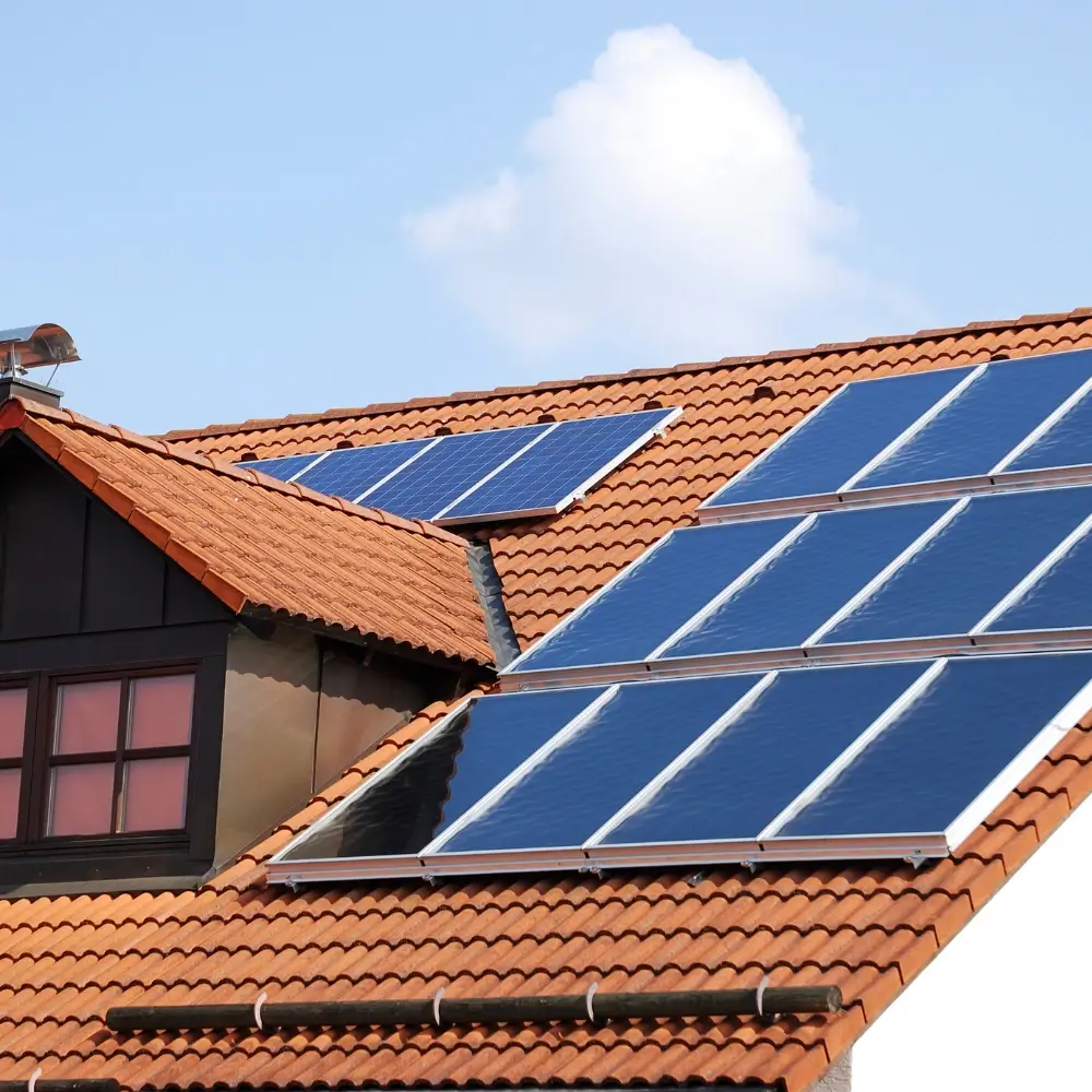 sun reflecting off of solar panels on a roof